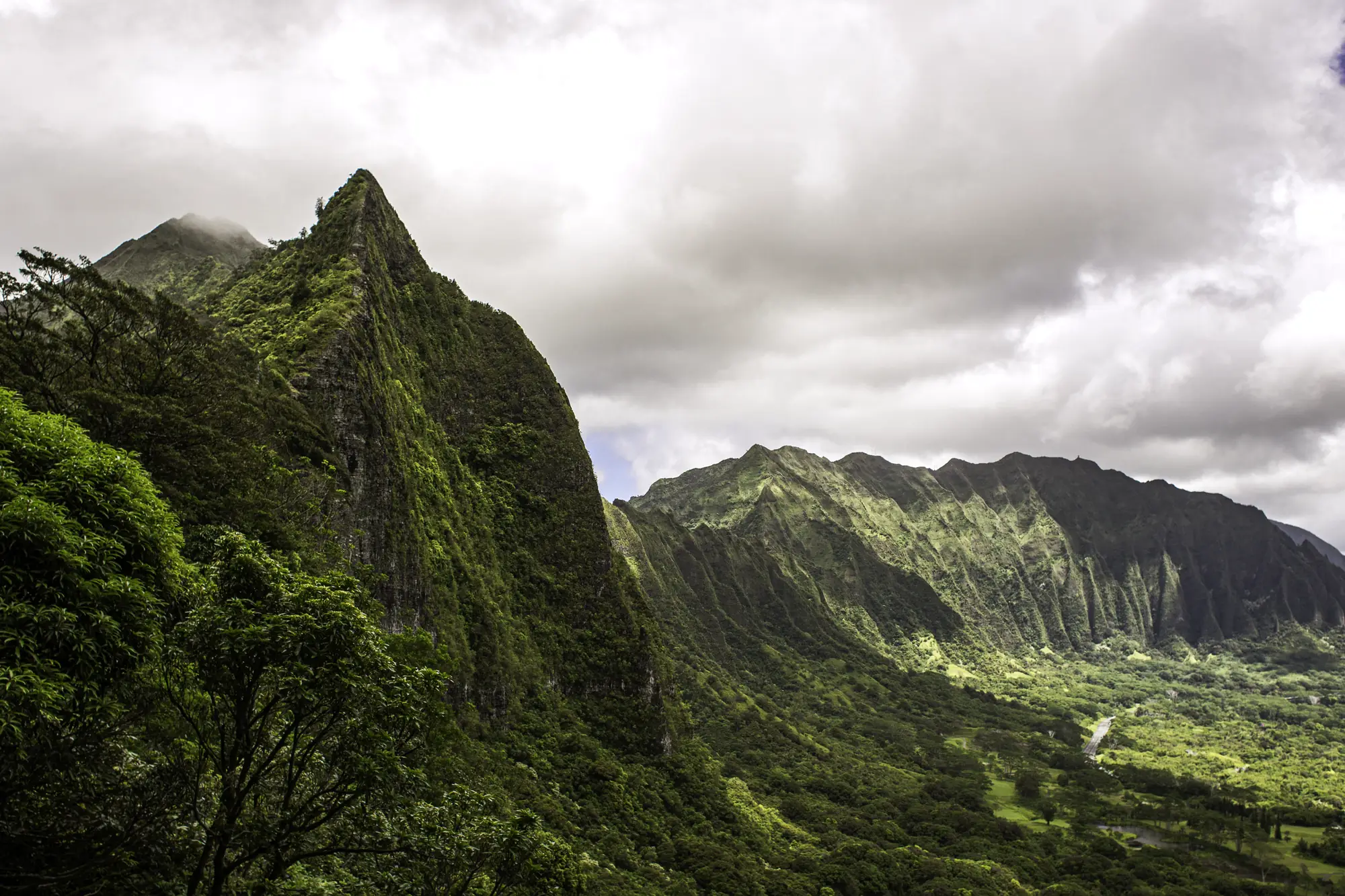 Green Koʻolau peaks under heavy cloud, photographed by Adam Grimm